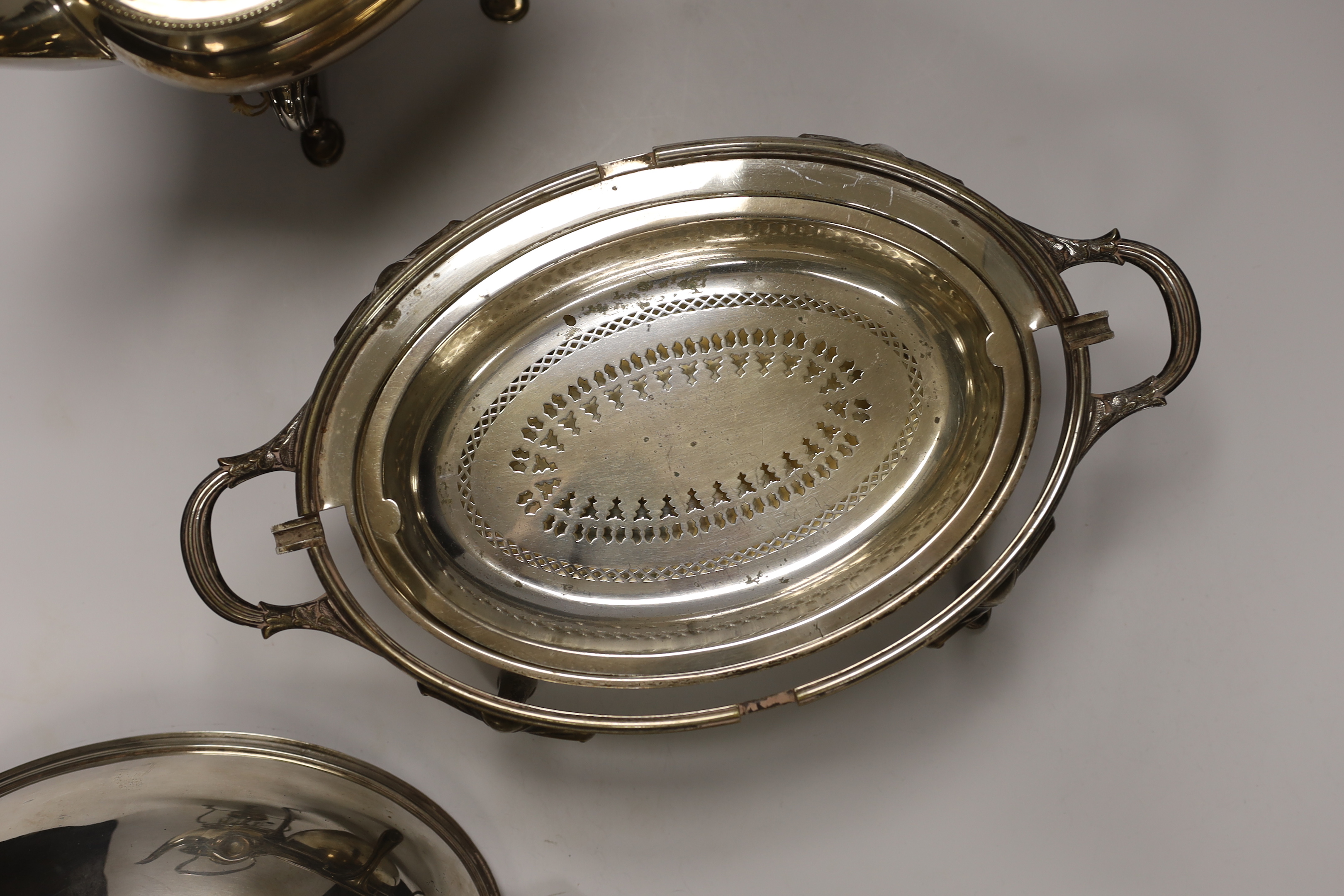 A plated breakfast dish with revolving lid and a tea kettle on burner stand, 31cm